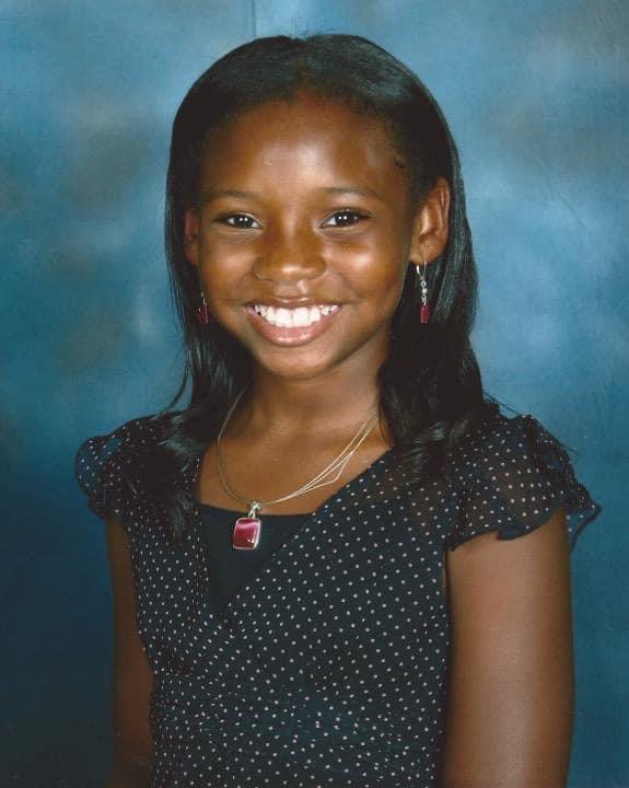 A young girl smiling for the camera.